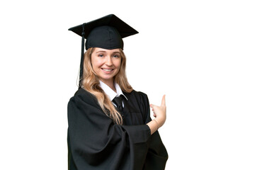 Young university English graduate woman over isolated background pointing back