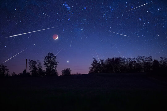 Starry Milky Way skies with comet and meteor shower, falling and shooting stars.