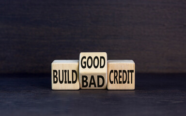 Build good or bad credit symbol. Concept word Build good or bad credit on wooden cubes. Beautiful black table black background. Business and build good or bad credit concept. Copy space.