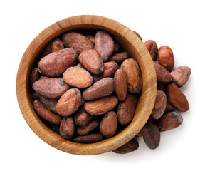 Cocoa beans in a wooden plate on a white background. Top view