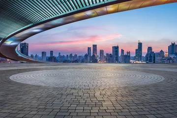Foto op Canvas Empty square floors and bridge with city skyline at sunset in Shanghai, China. © ABCDstock