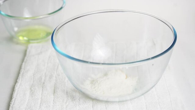 Pour a teaspoon of baking powder into a transparent bowl with eggs to prepare the dough. High quality 4k footage