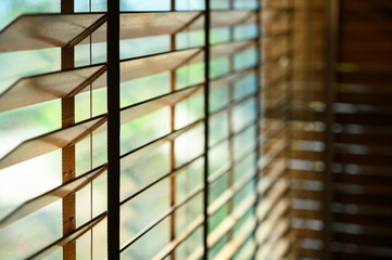 Close-up brown wooden blinds. lighting range control sunlight coming from a window. decoration interior. Modern jalousie.