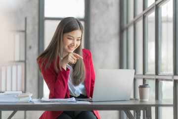 Beautiful asian accountant working with tablet computer in modern office with balance sheet, assets, stock market statistics, annual planning in office