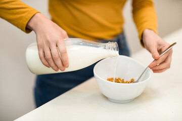 Obraz na płótnie Canvas Unrecognizable woman making healthy breakfast at home, closeup