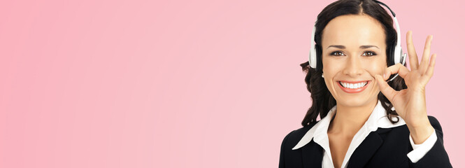 Call center service. Customer support phone sales operator in headset showing ok okay gesture, over rose pink background with copyspace area for text or slogan.