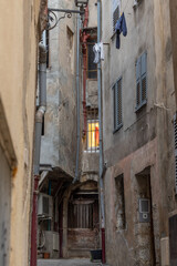 Fototapeta na wymiar Narrow alley with window in Grasse, France
