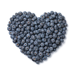 Fresh ripe raw blueberries in heart shape isolated on white background
