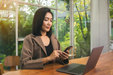 Young beautiful Asian woman working with laptop used the internet and shopped online, freelancer working businesswoman lifestyle concept