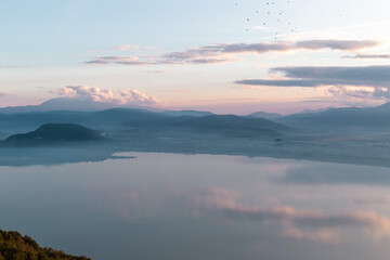 Fototapeta na wymiar sunset over the lake with mountains