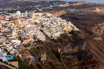 Fototapeta premium The whitewashed town of Fira in warm rays of sunset on Santorini island, Cyclades, Greece