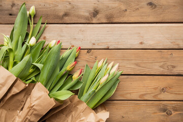 Row of tulips against a woden backgrund with space for the text.
