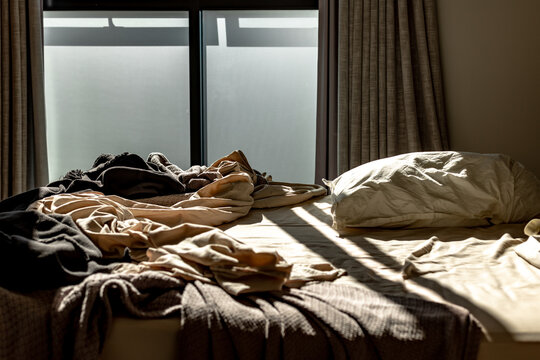 Messy unmade bed in the early morning
