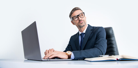 mature businessman wear eyeglasses in business office with laptop