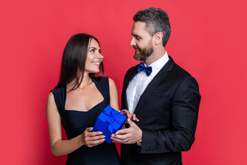 smiling love couple with present on background. photo of love couple with present box.