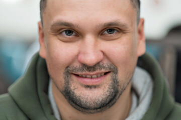 Portrait of a mature businessman wearing glasses on grey background. Happy senior latin man looking at camera isolated over grey wall with copy space. Close up face of happy successful business man. 