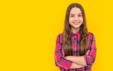 photo of teen girl with long hair wearing checkered shirt, copy space. teen girl isolated on yellow