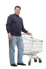 in full growth. casual mature man with shopping cart .