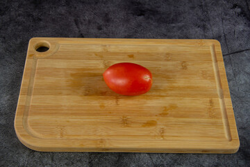 Red ripe tomato on a cutting board