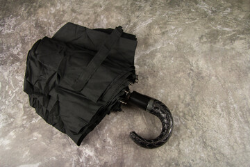 Black men's umbrella. A means of protection against precipitation