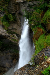 Fototapeta na wymiar A close-up view of the mighty Rychenbachfall waterfall in a mountain gorge near Meiringen, Switzerland