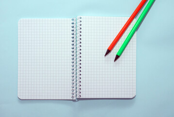 Top view blank notepad with colored pencils copy space. Planner notepad blank