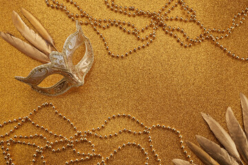 Mardi gras or carnival mask with beads on gold glowing background. Venetian mask. - obrazy, fototapety, plakaty