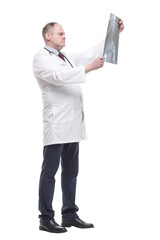 in full growth. qualified doctor looking at an x-ray .