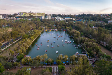 Baguio City, Philippines - Aerial of the man made lake of Burnham Park, with SM Baguio in the...
