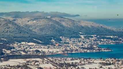 Beautiful alpine winter view with hot air balloons during the Montgolfiade Tegernsee 2023 at Rottach Egern, Bavaria, Germany