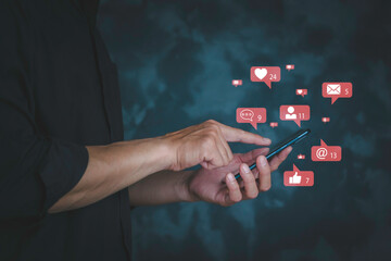 Businessman's hand using smartphone with social media notifications. The Concept  for social media marketing on mobile phone with notification icon of like, message, comment above mobile phone screen.