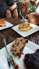 Vertical shot of eating traditional german Christmas stollen cake or Christstollen and other cakes together at a cafe