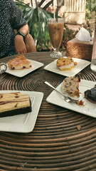 Vertical shot of eating traditional german Christmas stollen cake or Christstollen and other cakes together at a cafe