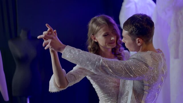 romantic embrace and dance of homosexual couple, two young gays dancing, same-sex marriage