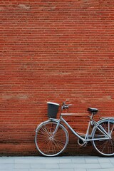 Fototapeta na wymiar Pastel blue Vintage style bicycle close with red brick wall background - generative ai