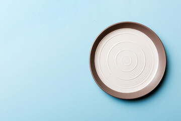 Fototapeta na wymiar Top view of isolated of colored background empty round white plate for food. Empty dish with space for your design