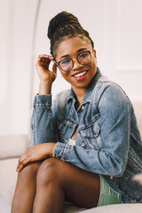 Attractive black woman sitting and smiling looking at camera