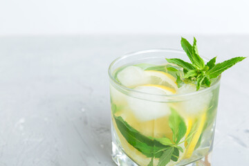 Mojito summer refreshing cocktail with ice and mint. mojito cocktail with lime, lemon and mint in a tall glass with a stick