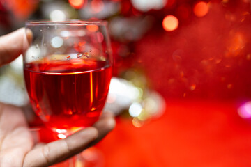 Champagne on red bokeh background. a wedding or valentine's Day concept with space for text.