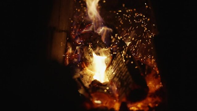 Kindling the stove with wooden logs in slow motion