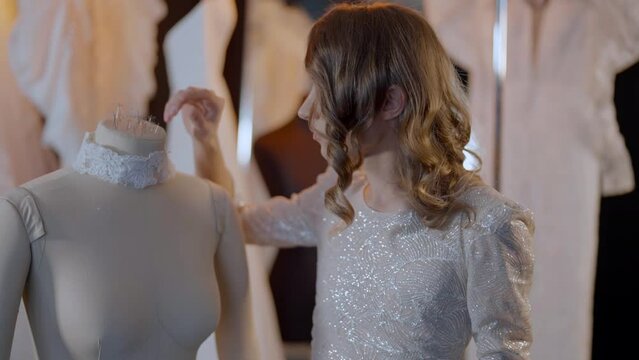 confident beautiful gay man in wedding atelier, portrait near mannequin, homosexual fashion designer