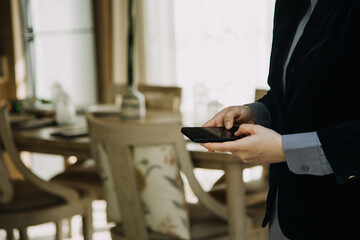 Mature businessman using a digital tablet to discuss information with a younger colleague in a modern business lounge