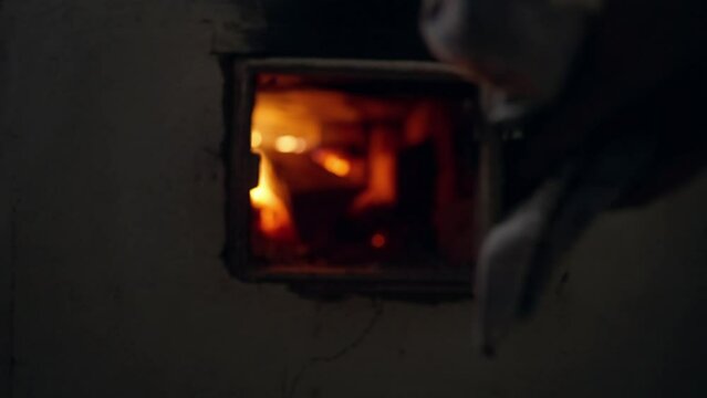 Opening the door for throwing firewood in an old stove