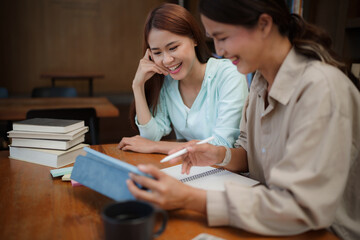 Asian student girl High School Tutor Individual Tuition From Teacher In Library. University Student Tutor books with friends.