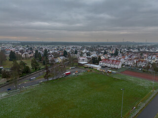Fototapeta na wymiar View over Weiterstadt Braunshardt on a cloudy, winter day with light snow