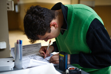 Obraz premium young architect boy working on a blueprint