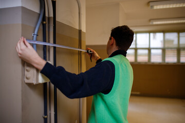 Young architect boy working on a blueprint
