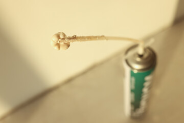 Metallic can with polyurethane foam, shallow depth of field.