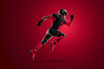 Fototapeta na wymiar American Football player in red and black uniform in running pose on red background. American Football, advertising poster, template, blank, sports. 3D illustration, 3D rendering.
