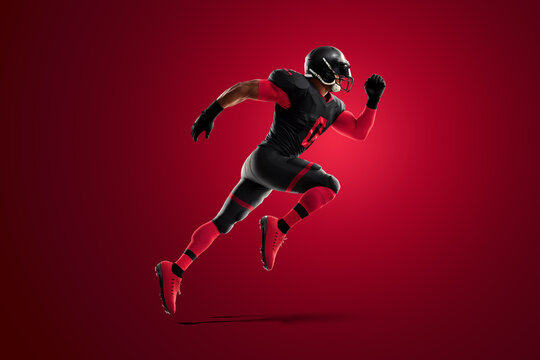 Premium Photo  American football player in red and black uniform in  running pose against stadium background american football advertising  poster template blank sports 3d illustration 3d rendering